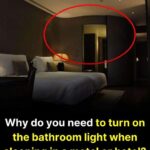 Why do you need to turn on the bathroom light when sleeping in a motel or hotel?